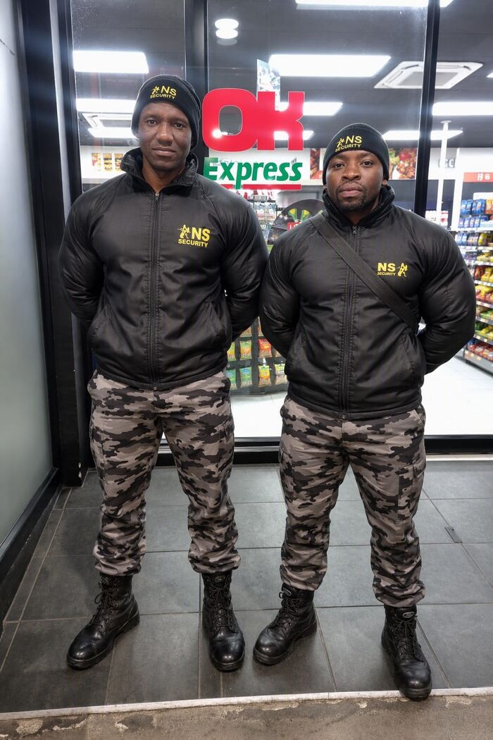 Two NS Security officers guarding a retail store entrance